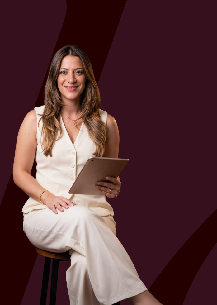 Izla Yacoub seated with a tablet